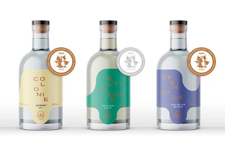 Three bottles of spirits produced at the Miellerie King Distillery.