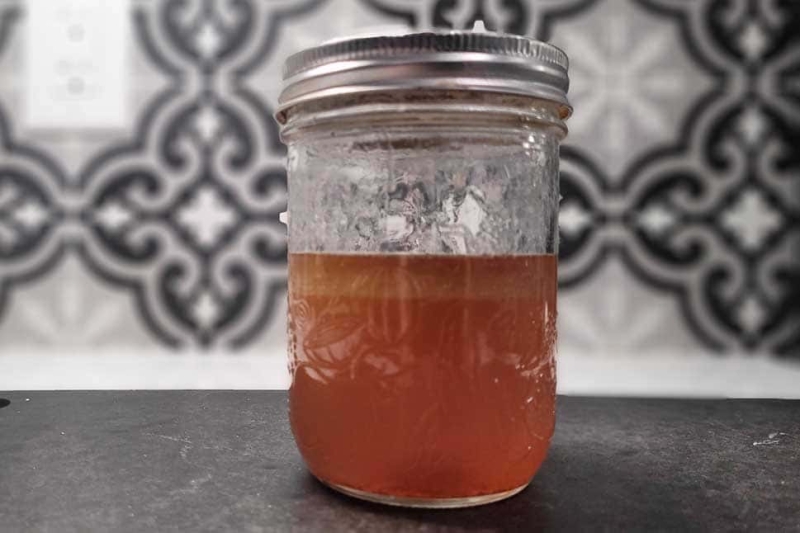 Jar of bourbon mixed with bacon fat.