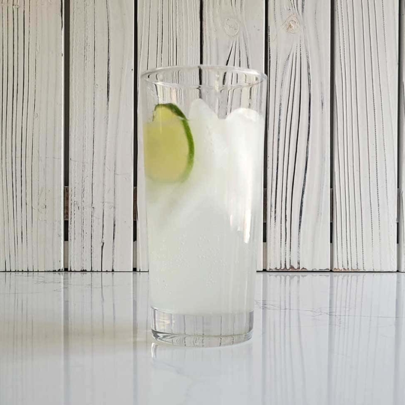 A paloma with a slice of lime on a counter.