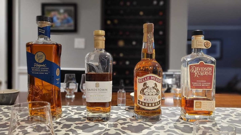 Bourbon bottles lined up for a whisky tasting.
