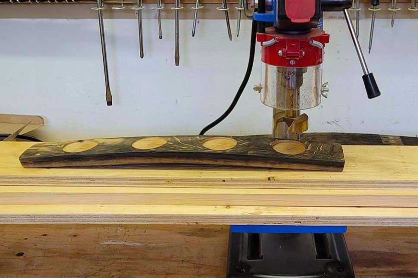 Drill press set-up to support stave to ensure vertical holes.